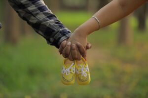 image with hands holding baby boots