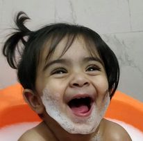 happy smiling  baby taking bath for personal hygiene